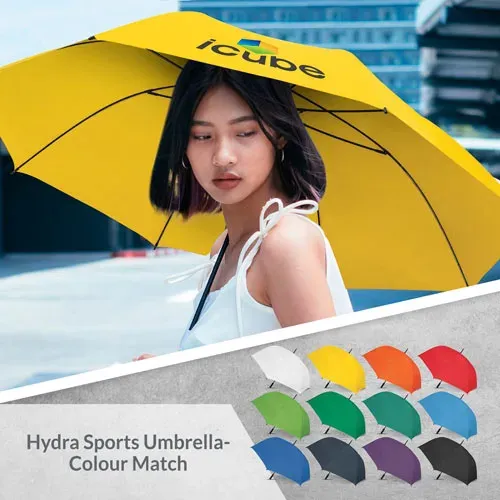 Person holding Hydra Sports umbrella in yellow, open profile view with colour range below