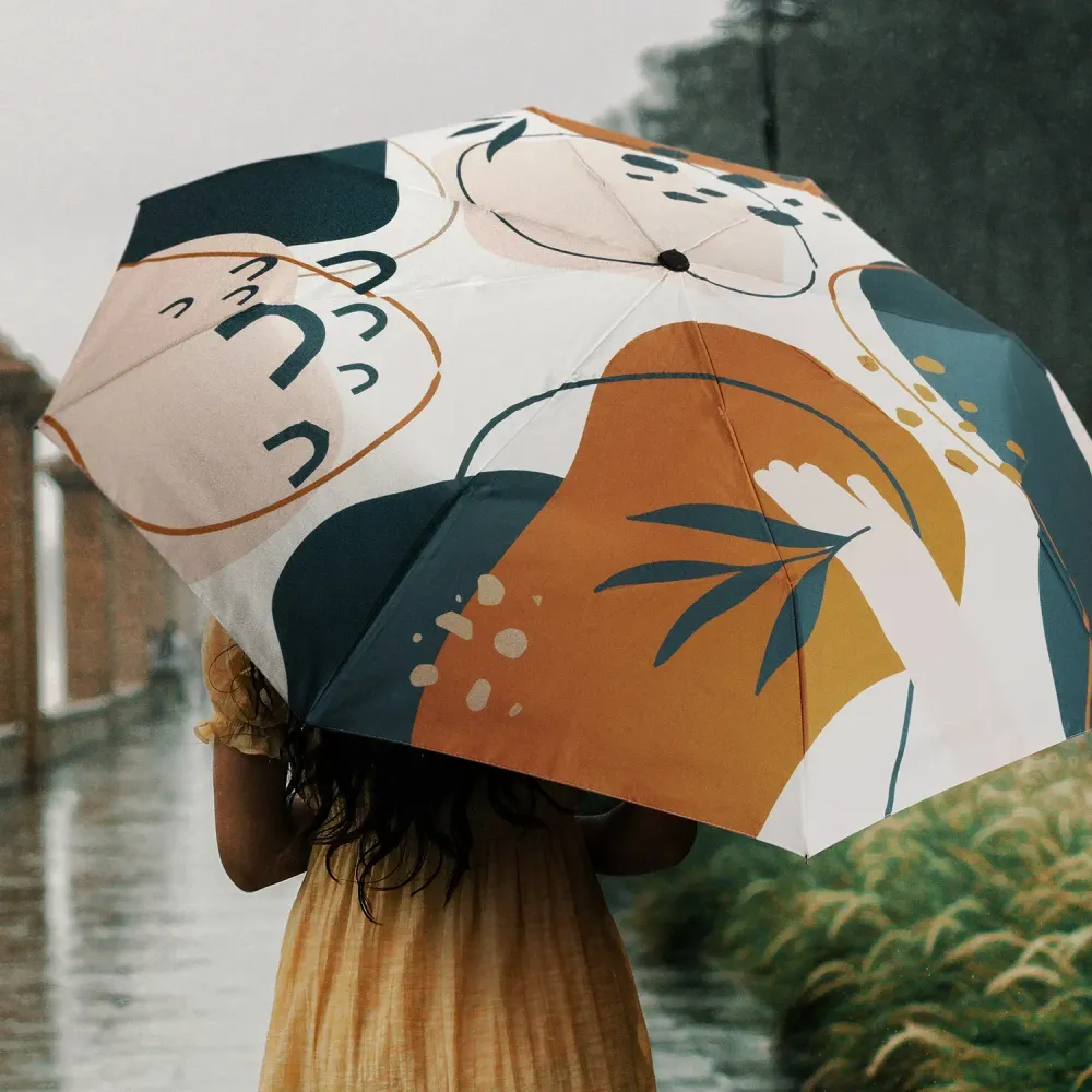 Person holding Full Colour Compact umbrella, open profile view with all-over print