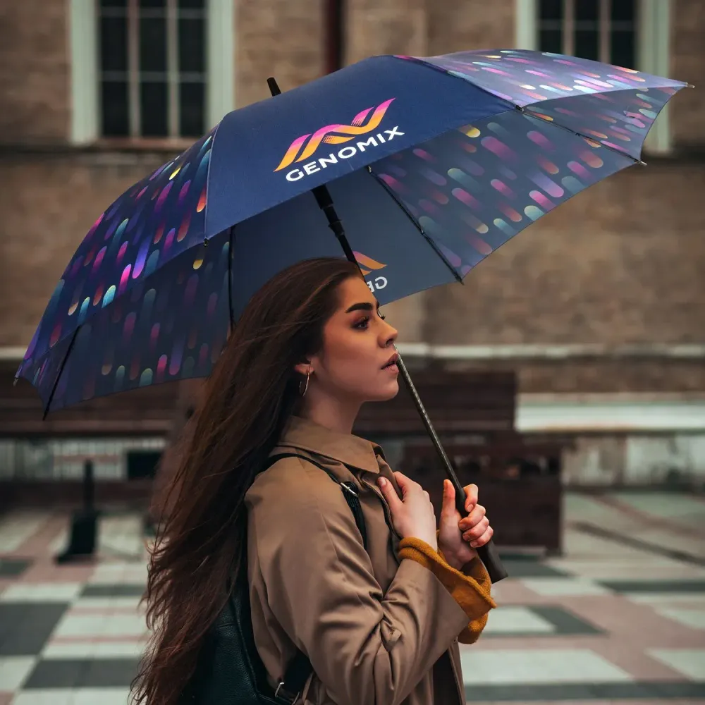Person walking outdoors holding Full Colour umbrella with all-over custom printed canopy artwork