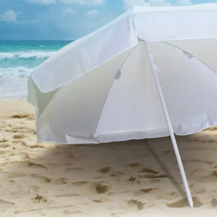 Bahama Beach umbrella in white set up on sand by the sea