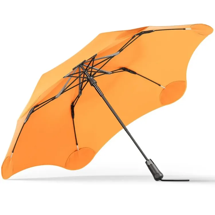 Angled underside view of BLUNT Metro Umbrella in mango orange showing frame and ribs