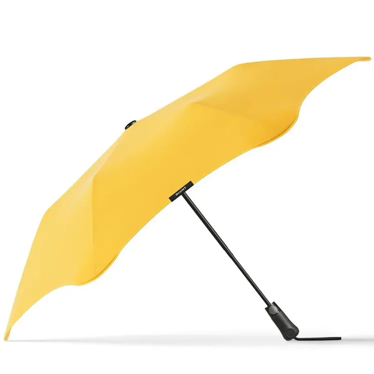 Side profile of BLUNT Metro Umbrella in citrus yellow with curved canopy and black handle