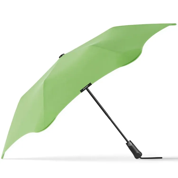 Side profile of BLUNT Metro Umbrella in meadow green with black shaft and handle