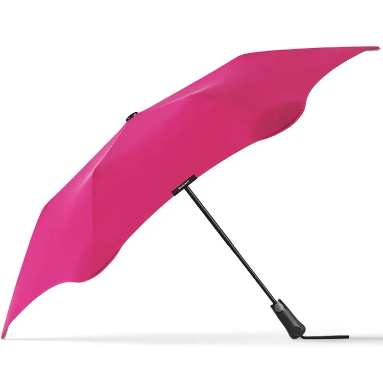 Side profile of BLUNT Metro Umbrella in pink with black shaft and ergonomic handle
