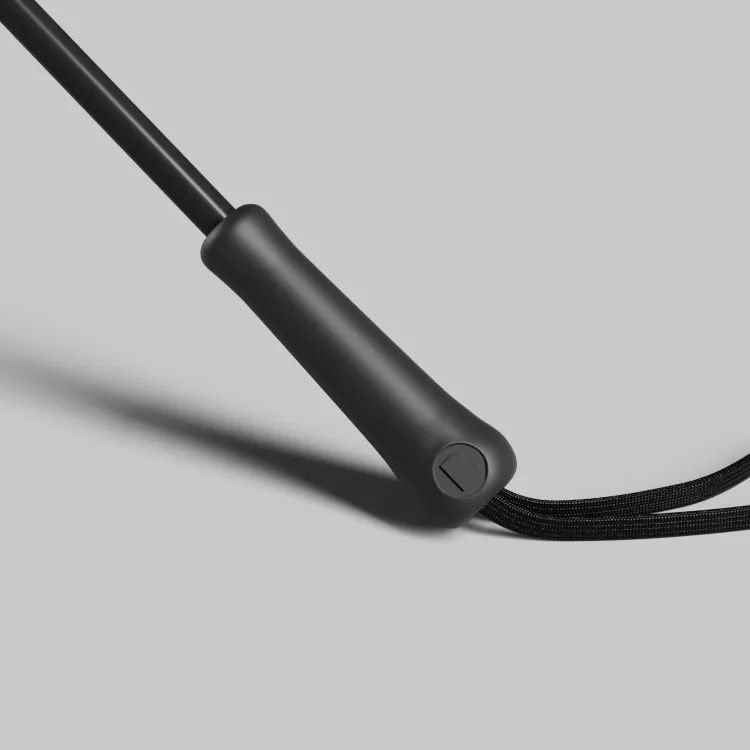 Close-up detail of BLUNT Metro UV umbrella handle showing textured grip and wrist strap