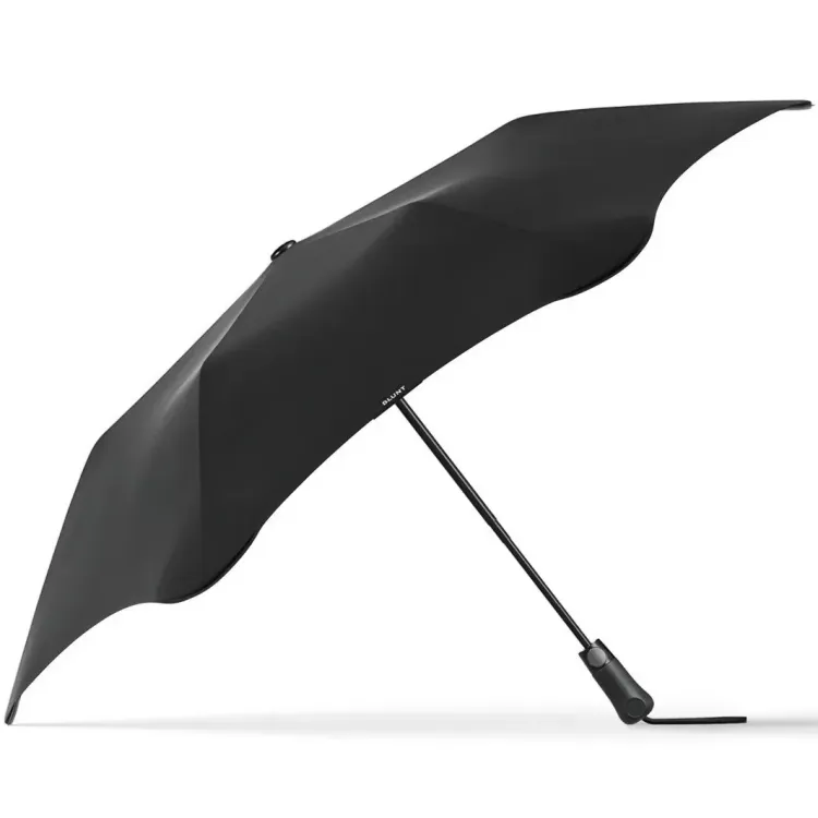 Side-angle view of black BLUNT Metro UV umbrella showing aerodynamic canopy and compact frame