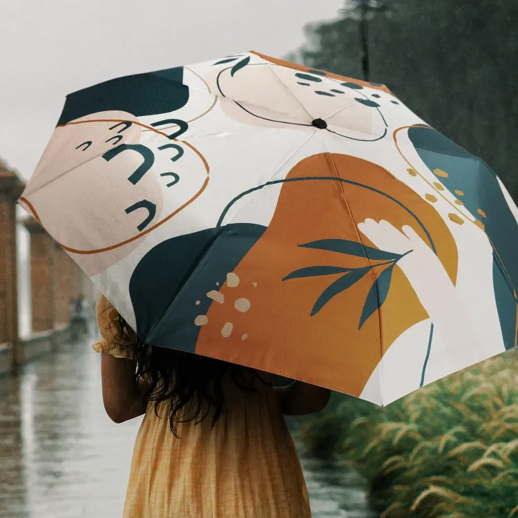 Person holding Full Colour Compact umbrella, open profile view with all-over print