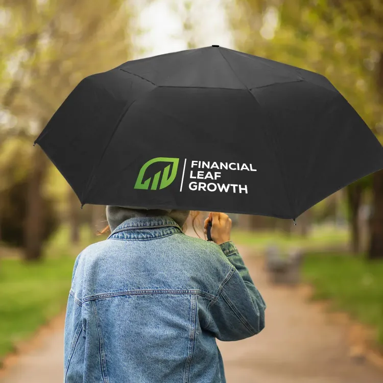 Person walking outdoors holding Hurricane City umbrella in black with branded panel