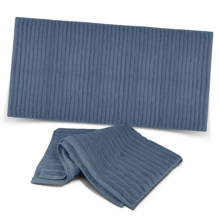 Palms Luxury Towel in slate blue with ribbed texture, shown folded and laid flat.
