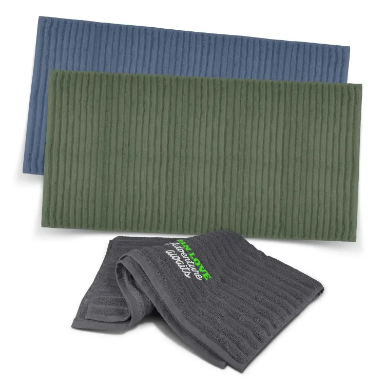 Palms Luxury Towels in charcoal, olive, and slate blue with ribbed texture, one featuring embroidered logo.