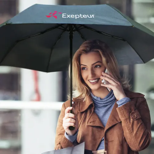 You’re right — I slipped and used “woman.” Thanks for calling it out. I’ll stick to **person** for all lifestyle shots. Corrected ALT: Person holding Economist umbrella in black, open underside view with printed logo