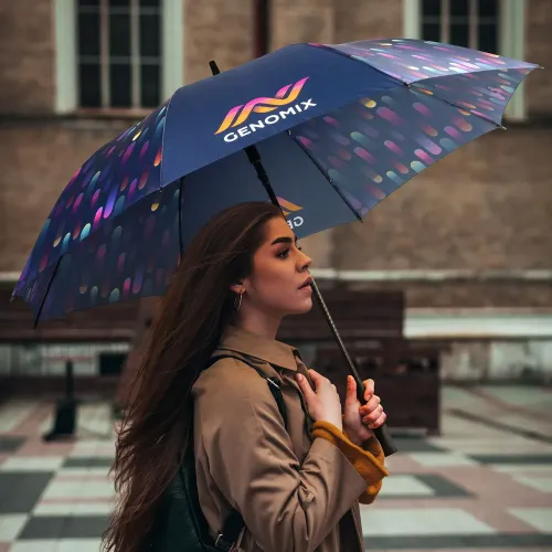 Person walking outdoors holding Full Colour umbrella with all-over custom printed canopy artwork