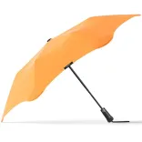 Side profile of BLUNT Metro Umbrella in mango orange with black shaft and handle