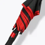 Close-up of closed Monsoon umbrella in black and red with red trims and push button