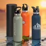 Nomad vacuum bottles with printed logos in assorted colours beside optional black gift tube.