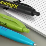 Branded Omega Pens with printed logos on lined notebook